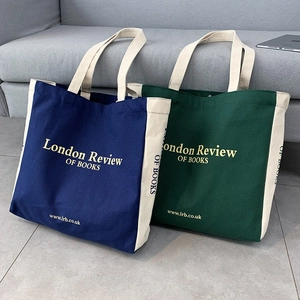 Vista dettagliata delle borse tote in tela blu navy e verde scuro con stampa London Review