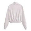 Detail of ribbed cuffs and collar on white cotton sweatshirt and flared pants set