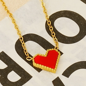 Detail shot of the red heart pendant with beaded edge on a 18k gold plated chain