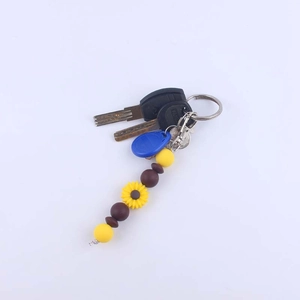 Silicone daisy sunflower beaded keychain with yellow beads and silver spring clip hook