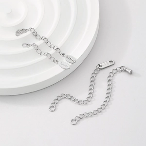 Detailed macro of 18K gold and stainless steel extension chains with S.Steel and K18 tags