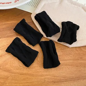 Set of 5 black high-elastic fabric hair scrunchies with minimalist knit ribbed texture