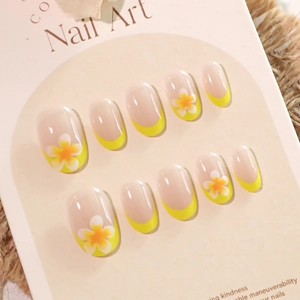 Short round French press-on nails with yellow tips and summer floral patterns