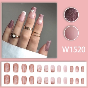 Pink press-on nail kit with glitter accents, French tips, and heart designs, 24 pieces