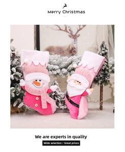 Detailed view of pink plush Christmas stocking featuring a 3D snowman and Santa ornament