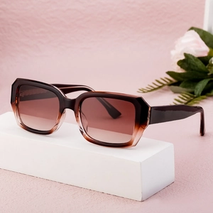 Brown gradient square cellulose acetate sunglasses displayed on a white block