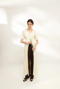 Detail of cream V-neck knit maxi cover-up dress with ribbed texture and side slit