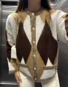 Detail view of plush geometric cardigan featuring retro metal buttons and knit texture