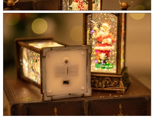 Close-up of Christmas lantern base showing battery compartment and Santa scene