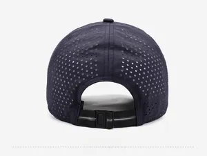 Detail of navy baseball cap featuring laser-cut ventilation holes and reflective strap