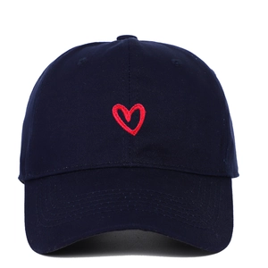 Close-up of a navy blue baseball cap with a detailed red heart embroidery on the front