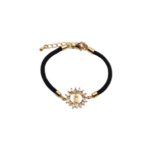 Detail of adjustable black woven bracelet with gold sunburst Virgin Mary pendant and zircons