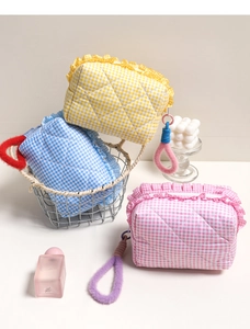 Quilted plaid makeup bags in yellow blue and pink colors with stylish ruffle trim