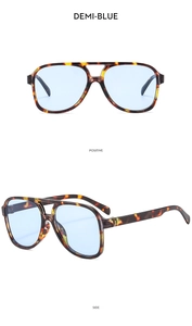 Detail view of double bridge pilot sunglasses with tortoise shell frame and demi-blue lens