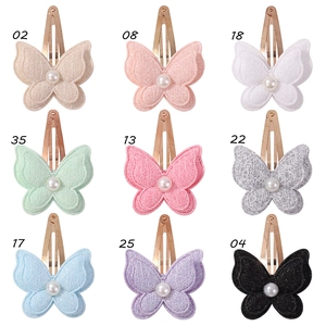 Nine colorful glitter butterfly hair clips with pearls shown in a grid layout