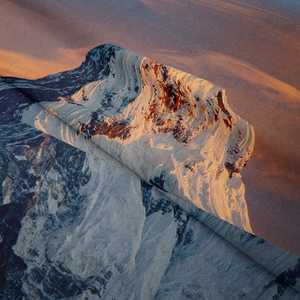 Detailed view of bohemian tapestry fabric with a snow mountain and sunset print texture