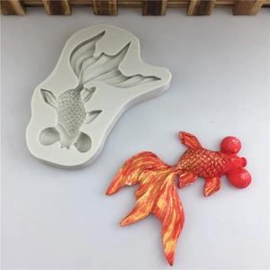 Macro view of grey silicone koi fish mold with detailed red and gold finished fondant carp