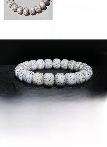 Detailed close-up showing texture of polished white Xingyue Bodhi seeds bracelet