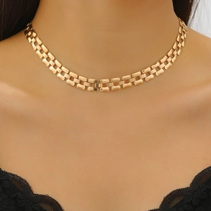 Close-up of a gold chunky choker necklace on model skin with rectangular polished links