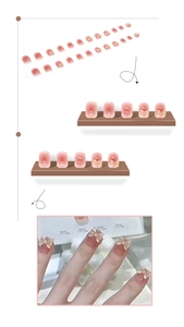 Detail of pink gradient press-on nails featuring 3D gold bows and jelly texture finish