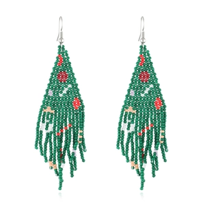 Macro view of handmade beaded Christmas tree tassel earrings with vibrant festive colors
