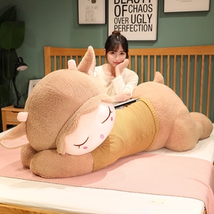 Long plush sheep toy skin in yellow sweater laying on bed as a decorative long pillow