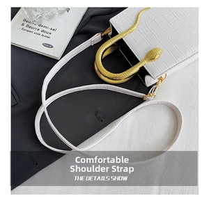 Detail showing white crocodile texture PU leather bag with gold snake-shaped metal handle