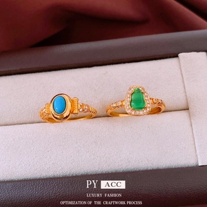 Vintage gold-plated open rings with turquoise and green gemstone in luxury jewelry box