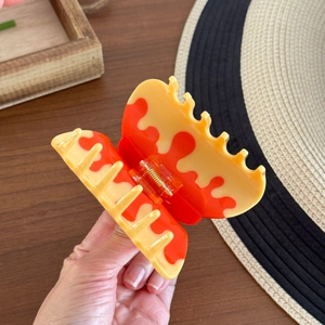 Elegant butterfly acetate hair claw clip with orange and yellow marble pattern for women