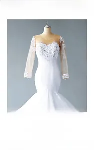 Detail showing the intricate sequin beadwork and lace applique on white mermaid wedding dress
