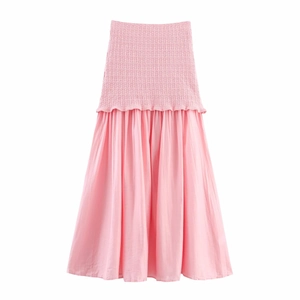 Detail of pink knitted dress with elastic high waist and pleated tiered hemline design