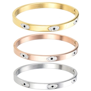 Close-up of evil eye stainless steel bangles with sparkling crystals in three colors