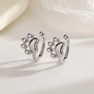 Macro view of S925 sterling silver cat paw ear cuff with polished finish and hallmark