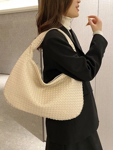 French woven beige leather tote bag for women showing a stylish minimalist shoulder carry look