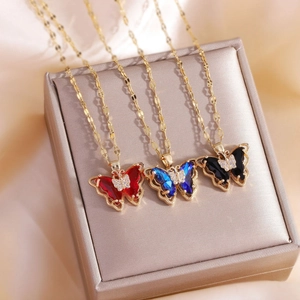 Gold-plated butterfly necklace with colorful crystal inlay on a champagne jewelry box