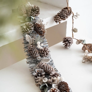 Rustic Christmas garland with natural pine cones, grey twigs and white berries decoration