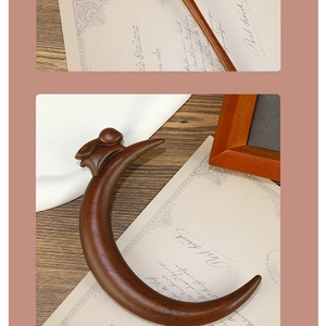 Detailed view of crescent-shaped sandalwood hairpin with rabbit carving and retro styling