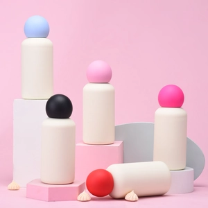 Close-up of portable matte stainless steel water bottles with colorful spherical lids