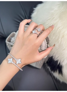 Detailed close-up of silver-tone ginkgo leaf bracelet and ring with white mother-of-pearl