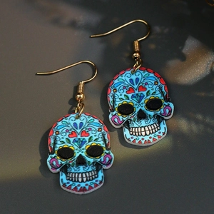 Colorful blue acrylic skull drop earrings with intricate patterns and gold metal hooks