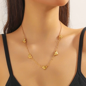 Close-up of a gold-plated stainless steel chain necklace with multiple heart charms