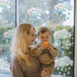 Rainbow prism cloud window film showing a mother and child in a cozy home setting
