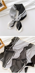 Detail of a 70cm black and white geometric silk scarf with modern grid pattern