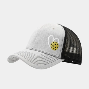 Detail shot of the breathable mesh back and embroidered pickleball heart on a sports cap