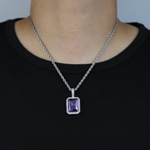 Close-up of a square purple gemstone pendant necklace with a twist chain on a model