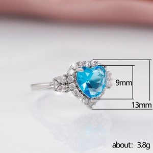 Detail of blue heart-shaped ring measuring 9mm x 13mm with white zircon accents