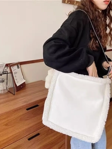 White faux leather shoulder bag with plush shearling trim for elegant daily commuting