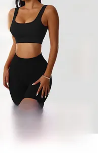 Close-up of high-elasticity black ribbed yoga set featuring U-neck top and seamless shorts