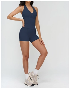 Detail of navy blue V-neck halter sports top and high-waisted shorts in elastic fabric