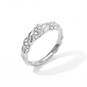 Macro shot of silver twisted metal ring featuring intricate pavé-set crystal stones